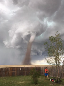 Man who mowed lawn with tornado behind him says he 'was keeping an eye on it.' - Cecilia Wessels snapped the picture of her husband, Theunis
